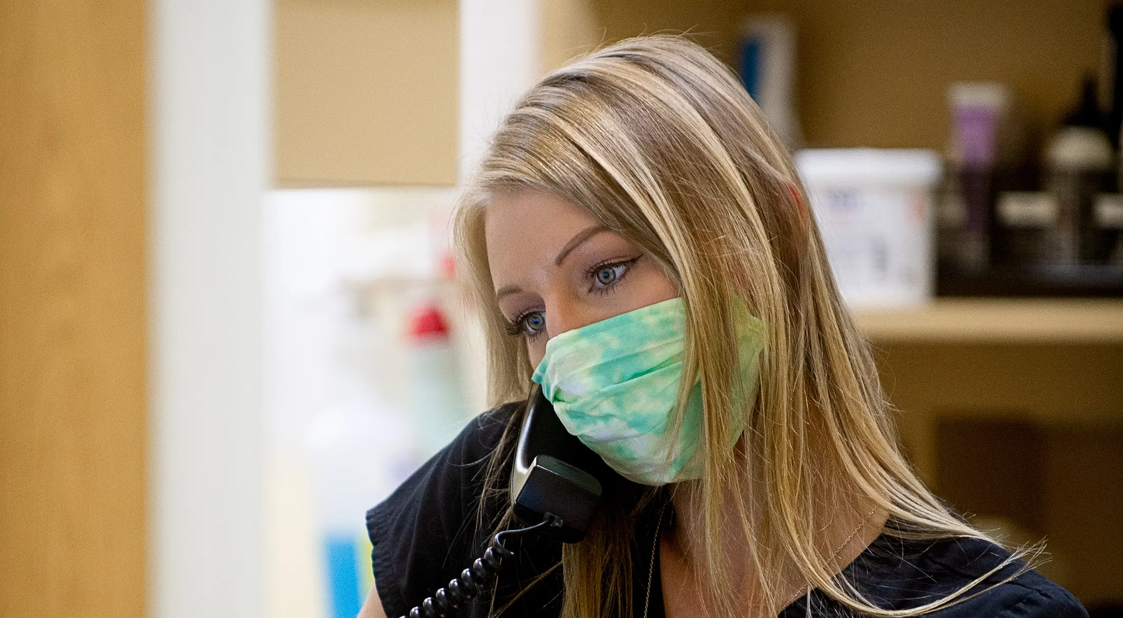 A vet tech on the phone in the pharmacy