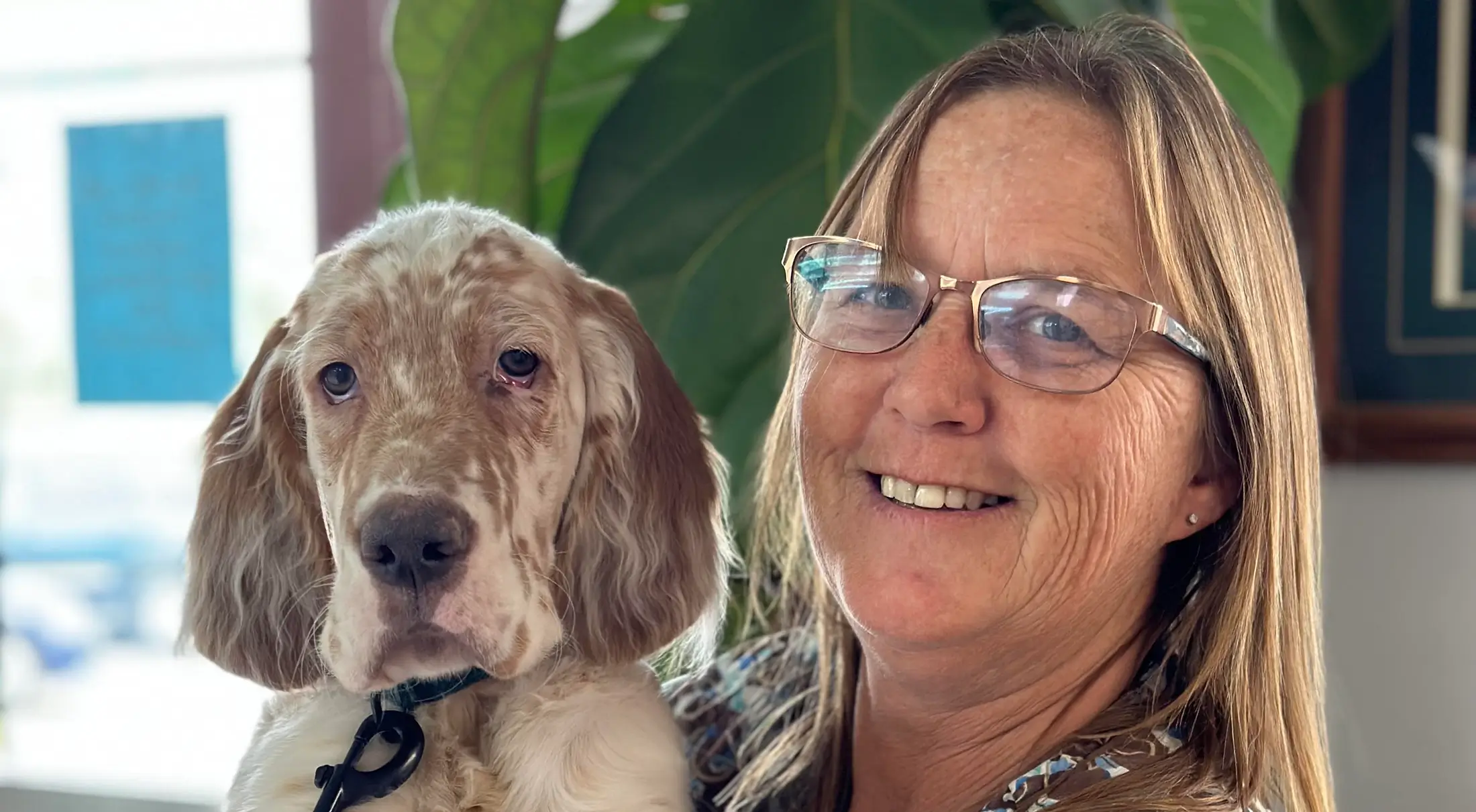 A vet tech with a happy dog